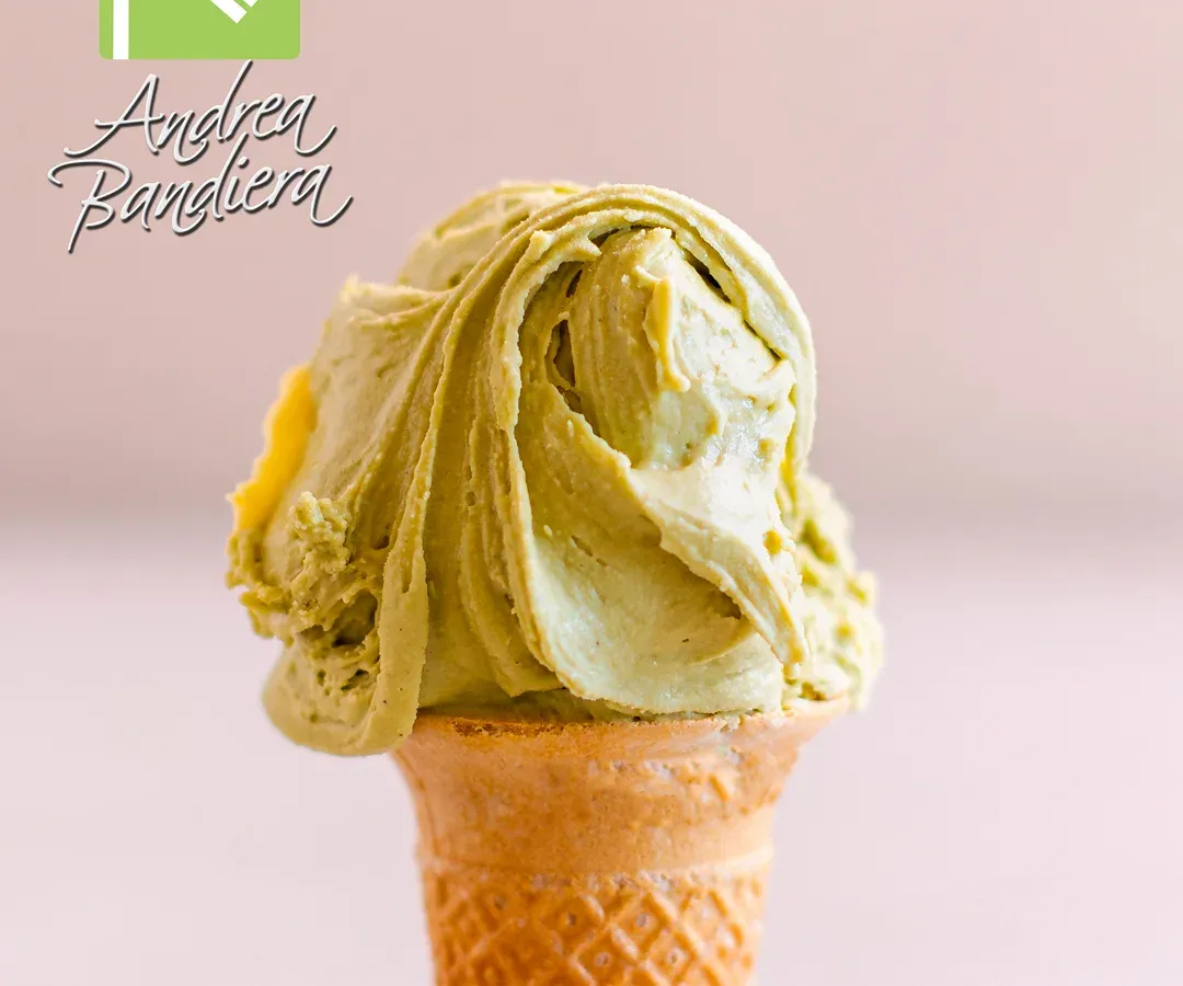 Pistachio gelato served on a cone.
