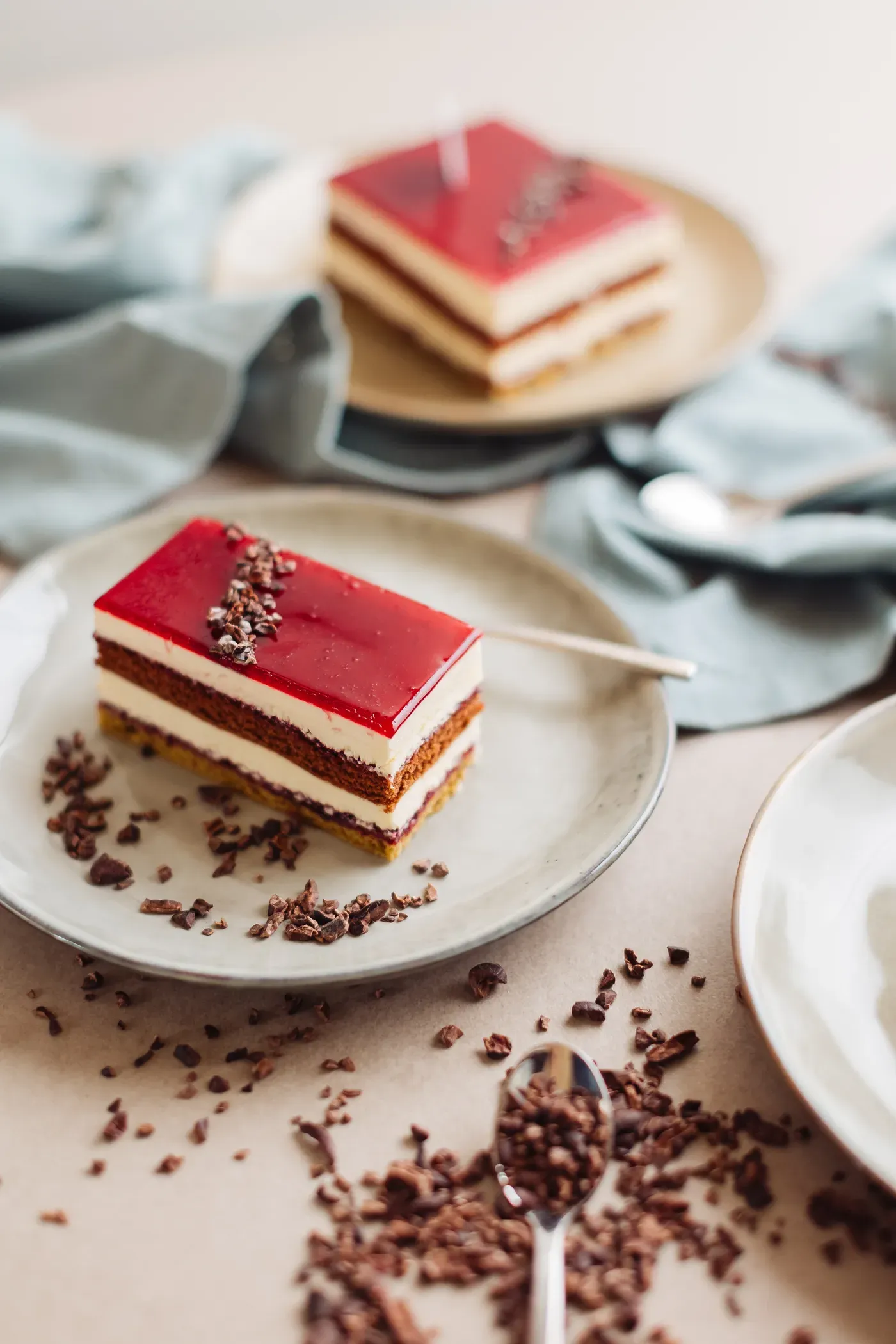 Loren semifreddo with red glaze and cocoa garnish on a light plate.